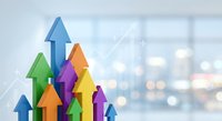 Colorful arrows pointing upward representing business growth, success, progress and achievement against blurred office background with bokeh lights.