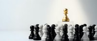 Golden pawn standing out among black and white chess pieces on light background, symbolizing leadership, uniqueness and strategic thinking in business.