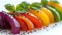 Colorful bell peppers arranged in rainbow gradient with fresh basil leaves and black sesame seeds on white background, macro food photography for restaurant menu.