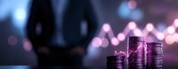 Stacks of coins in purple neon lighting against blurred financial chart background showing market growth trends and investment concept for finance presentation.