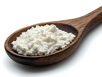 Fresh cottage cheese in wooden spoon on white background, dairy product close up macro photography, healthy protein food ingredient isolated.