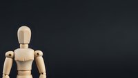 Wooden artist mannequin figure on dark background with copy space for creative design projects and artistic compositions.