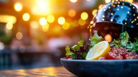 Fresh salmon tartare garnished with lemon, capers and microgreens served in dark ceramic bowl against blurred warm bokeh lights background. Perfect for menu design.