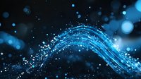 Glowing blue light trails with sparkles and bokeh effects on dark background create dynamic flowing energy waves for technology concepts.