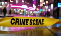 Yellow police tape with crime scene text against blurred urban nightlife background with colorful bokeh lights and reflections on wet surface. Dramatic law enforcement setting.