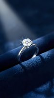 Elegant diamond engagement ring with brilliant cut stone on luxurious blue velvet fabric with dramatic lighting for wedding and jewelry concepts.