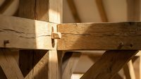 Traditional wooden joinery showcasing mortise and tenon construction techniques in natural oak timber frame carpentry work.