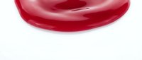 Red glossy liquid drop or gel texture isolated on white background for cosmetic and skincare product design applications.