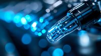 Macro shot of fiber optic cable end with blue light bokeh background showing digital data transmission and network connectivity concept.