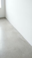 Empty modern room corner with polished concrete floor and white walls showcasing minimalist interior design for contemporary residential spaces.