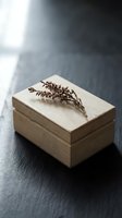 Wooden jewelry box with dried botanical branch on dark slate surface creating minimalist natural home decor composition for storage and organization.