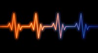 Glowing heartbeat pulse wave with orange to blue gradient on black background for medical healthcare technology design projects.