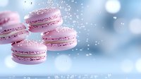 Pink macarons floating in air with water droplets and sparkles against soft blue background, creating magical pastry composition for food advertising.