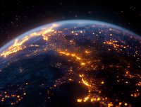 Planet Earth view from space showing illuminated citiesowing lights and energy paths across global network.