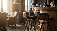 Modern bar stools with wooden seats and metal legs at counter in contemporary restaurant or cafe interior with warm lighting and blurred background.