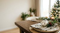 Rustic wooden table set with festive holiday decorations, white plates, napkins and ornaments for seasonal dining and celebration entertaining.