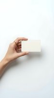 Female hand holding blank white business card mockup on clean background for branding and corporate identity design projects.