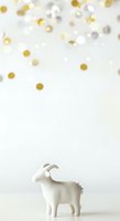 Decorative white goat figurine with metallic horns positioned below falling gold, silver, and white confetti circles on neutral background, suitable for festive celebrations, holiday greeting cards, and seasonal marketing materials.