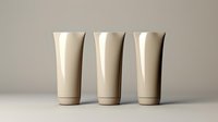 Minimalist cream-colored cosmetic tubes standing in row on neutral background. Clean product mockup for skincare, beauty or personal care packaging design.