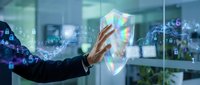 Professional hand touching holographic cybersecurity shield with digital data streams and network connections in modern office environment.