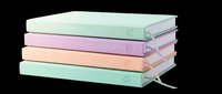 Stacked hardcover books in pastel colors with decorative bookmarks, isolated on transparent background. Ready for clipart, t-shirt design, print-on-demand, stickers, and sublimation projects.