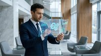 Professional businessman in suit interacting with holographic digital interface displaying data analytics and charts in modern corporate office environment.