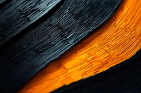 Contrasting textured surfaces with vibrant orange glow between dark black layers creating abstract modern design element for backgrounds.