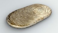 Oval stone with carved spiral pattern on white background, natural zen meditation object featuring concentric circular grooves and weathered texture. Isolated.