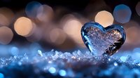 Frozen heart-shaped ice crystal surrounded by sparkling snow and bokeh lights, symbolizing winter love, cold emotions, and seasonal romance for holiday designs.