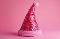 Glittery festive party hat with sparkly texture isolated on pink background, suitable for holiday celebrations, event design, and seasonal marketing materials.