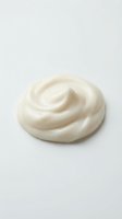 Creamy white swirl of whipped dairy product or cosmetic lotion isolated on neutral background, suitable for food, beauty, and skincare marketing materials.