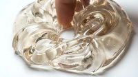 Transparent gel or clear cosmetic serum with flowing, viscous texture isolated on white background, suitable for skincare product packaging, beauty advertising, and cosmetic design applications.