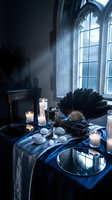 Gothic interior with candles, ornate chalice, black feathers and eggs on blue silk cloth near arched windows. Dark atmospheric scene for mystical design projects.