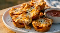 Golden baked egg muffins with melted cheese and herbs served on white plate with dipping sauce for breakfast brunch meal preparation healthy protein snacks.