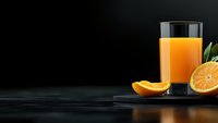 Fresh orange juice in glass with sliced citrus fruits and green leaves on dark background with copy space, healthy breakfast drink concept.