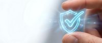 Hand holding glowing neon shield with checkmark symbol, representing cybersecurity, data protection, and digital safety for business and technology concepts.