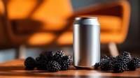 Blank aluminum beverage can surrounded by fresh blackberries on wooden surface with orange chair in blurred background.