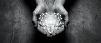 Hands holding glowing geometric light energy sphere against dark textured background, symbolizing power, innovation, and spiritual connection for design projects.