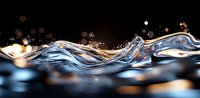 Elegant liquid wave with golden bokeh lights on dark background creates dynamic splash effect. Macro photography of water surface with reflections.