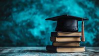 Stack of old books topped with black graduation cap and red tassel against blurred turquoise background, dramatic lighting creates academic atmosphere.