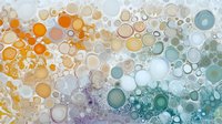 Abstract colorful bubble pattern with overlapping circles in orange, purple and teal gradient creating modern artistic background for design projects.
