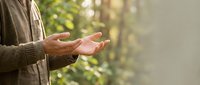 Man with open hands gesturing outdoors in natural sunlight, expressing openness, freedom, or receiving concept for wellness and lifestyle content.