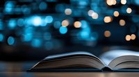 Open book with blurred blue and golden bokeh lights in background creates magical reading atmosphere for education and literature concepts.