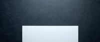 Blank white rectangular card or paper on dark slate textured background, ready for design mockups, branding presentations, and marketing materials.