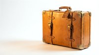 Vintage brown leather suitcase with metal buckles and handle isolated on white background for travel and retro design projects.