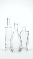 Three empty clear glass bottles of different shapes and sizes arranged together on white background isolated for product design and packaging concepts.