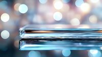 Sleek glass test tube with liquid against blurred blue and white bokeh background creates modern scientific laboratory atmosphere.