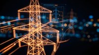 Digital electric power transmission tower with glowing orange lines and data interface overlay against blurred city lights background at night.