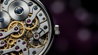 Luxury mechanical watch movement with exposed gears and jewels showcasing precision craftsmanship and intricate clockwork engineering details.