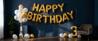 Gold foil balloon letters spelling Happy Birthday with number 3 balloon and white gold balloons against dark blue wall in elegant party room.